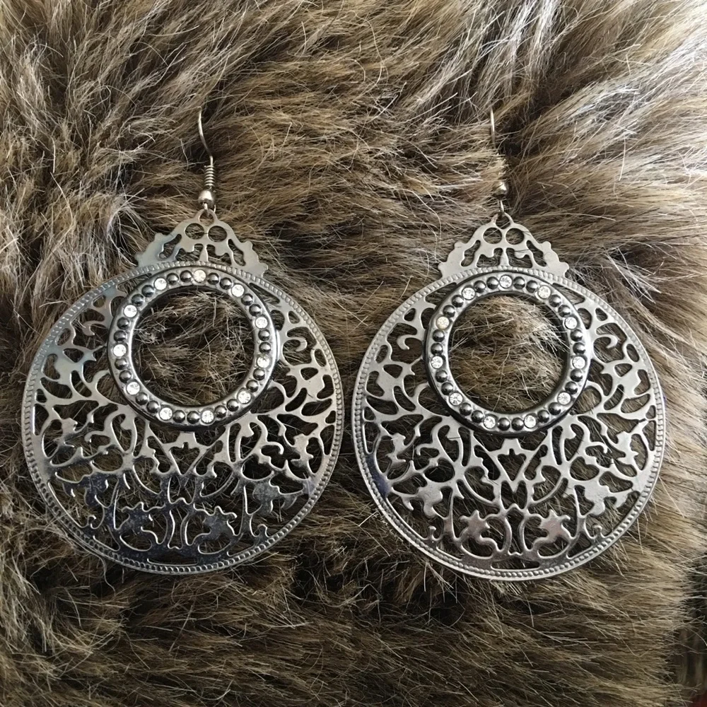 Large chrome tone scroll rhinestone earrings